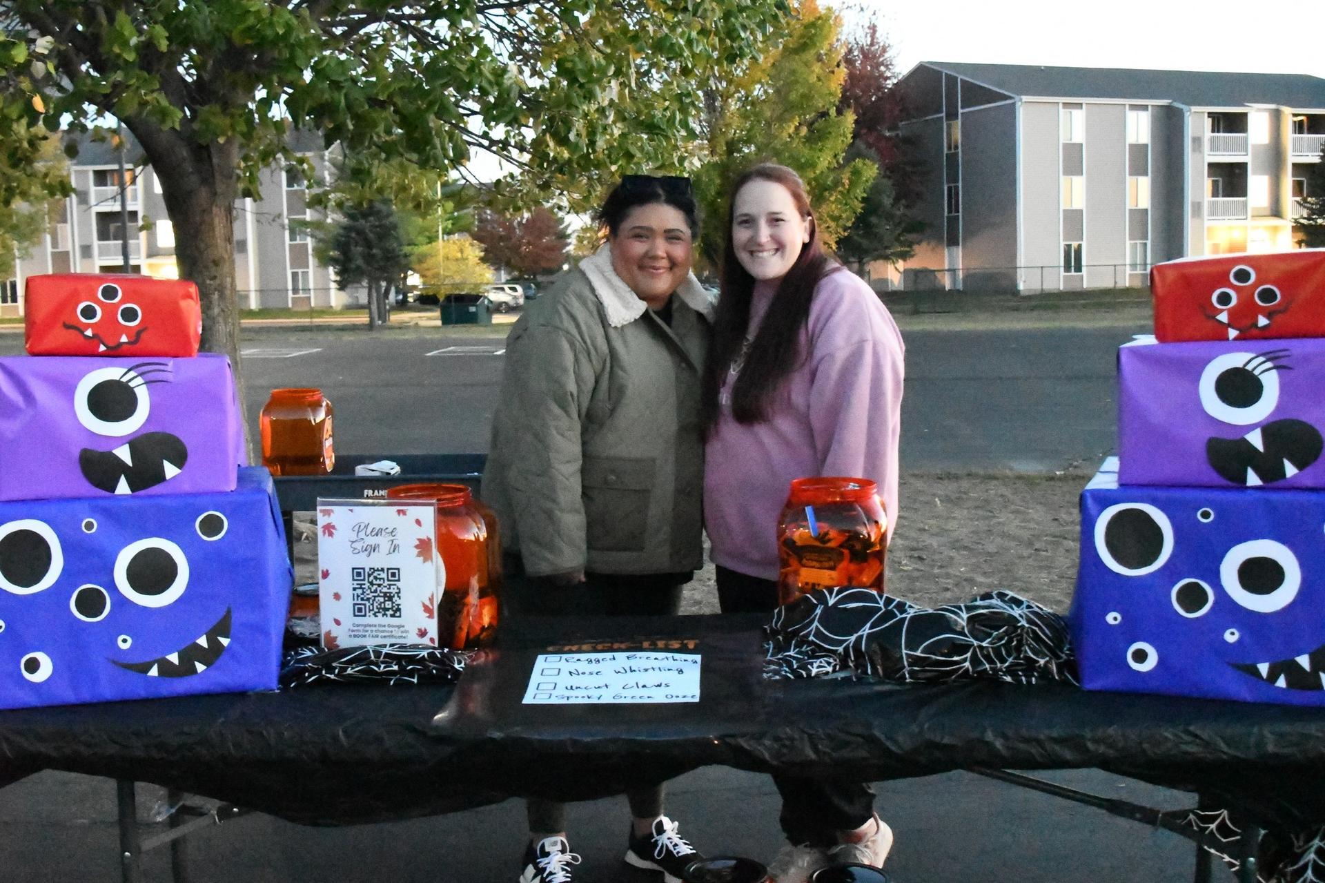 Picture of WES Trunk-or-Treat event; staff at event table